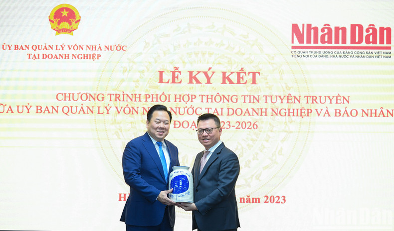 黎国明总编辑向阮黄英同志赠送纪念品。