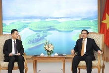 政府总理范明正会见老挝工贸部部长马来通·康马西。（图片来源：越通社）