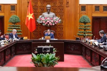 越南政府总理范明正主持召开国防部和公安部机构改革工作会议。（图片来源：VGP）