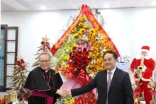 内务部副部长武战胜向顺化天主教总教区总主教阮志灵赠送鲜花。