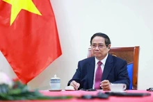 越南政府总理范明正与新西兰总理克里斯托弗·拉克森通电话（图片来源：越通社）