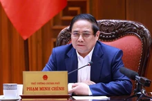 越南政府总理范明正要求尽早确定实行免费医疗的路线图。（图片来源：VGP）