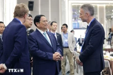 范明正总理与企业代表在会议间隙交流。