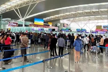 附图:游客在内排国际机场办理登机手续。