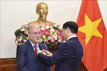 裴青山外长授予德国世界大学服务机构主席卡姆比斯•加瓦米友谊勋章。（图片来源：越通社）