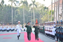 越南国防部部长潘文江大将与老挝国防部部长坎良·奥萨宋上将检阅仪仗队。（图片来源：人民军报）