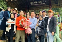 风芽-盖板旅游中心主任黄明胜在开放首日向游客送花。