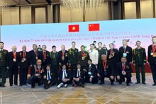 在庆祝越中建交75周年招待会上，中国援越老兵与越南驻华使馆武馆处和越南公安部驻华代表处官员合影。（杜有兴 摄）