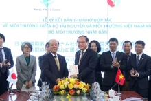 越南自然资源与环境部副部长黎功成和日本环境省国务大臣八木哲也签署双方合作备忘录。（图片来源：越通社）
