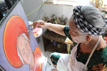 邓爱越女士自2010年起，历时十年走遍全国，为越南英雄母亲绘制肖像。​图片来源：越南画报