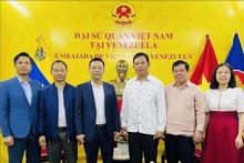 越南友好组织联合会代表团与越南驻委内瑞拉大使馆代表合影。