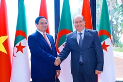 越南政府总理范明正与阿尔及利亚总理赛菲·喀里布。（图片来源：越通社）