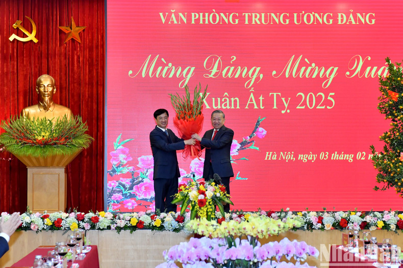 越共中央办公厅主任阮维玉向苏林总书记赠送鲜花。