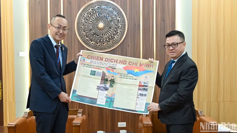 《人民报》社总编辑黎国明向小林洋介先生赠送《人民报》特别副刊。