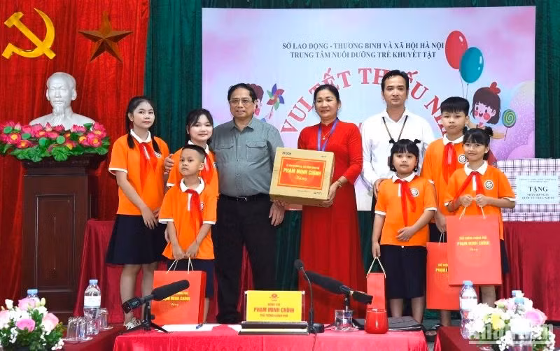 范明正总理向河内残疾儿童养育中心孩子们赠送礼物。