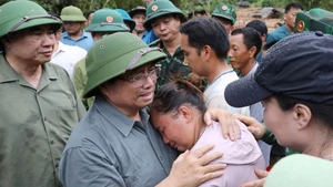 范明正总理对洪水灾区民众失去亲人的悲痛感同身受。（图片来源：越通社）