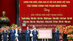 范明正总理向《越南之声》赠送礼物。
