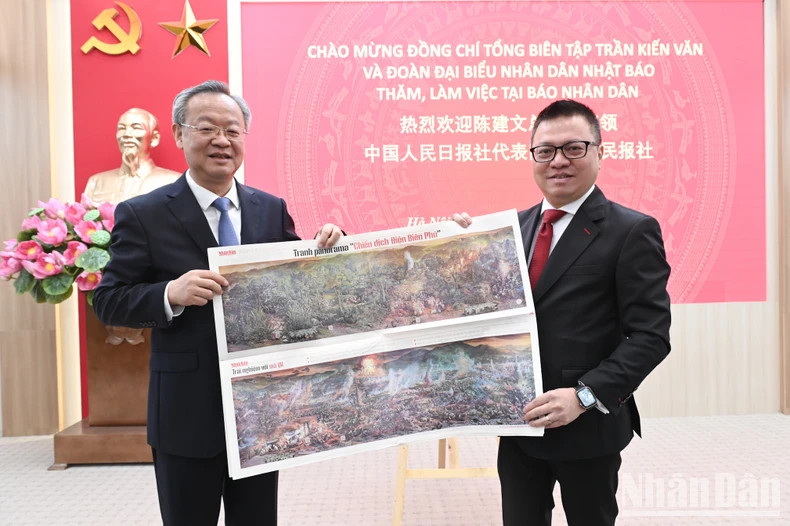 黎国明同志向陈建文同志介绍《奠边府战役》全景图副刊。(裴江 摄) 黎国明同志向陈建文同志介绍《奠边府战役》全景图副刊。(裴江 摄)