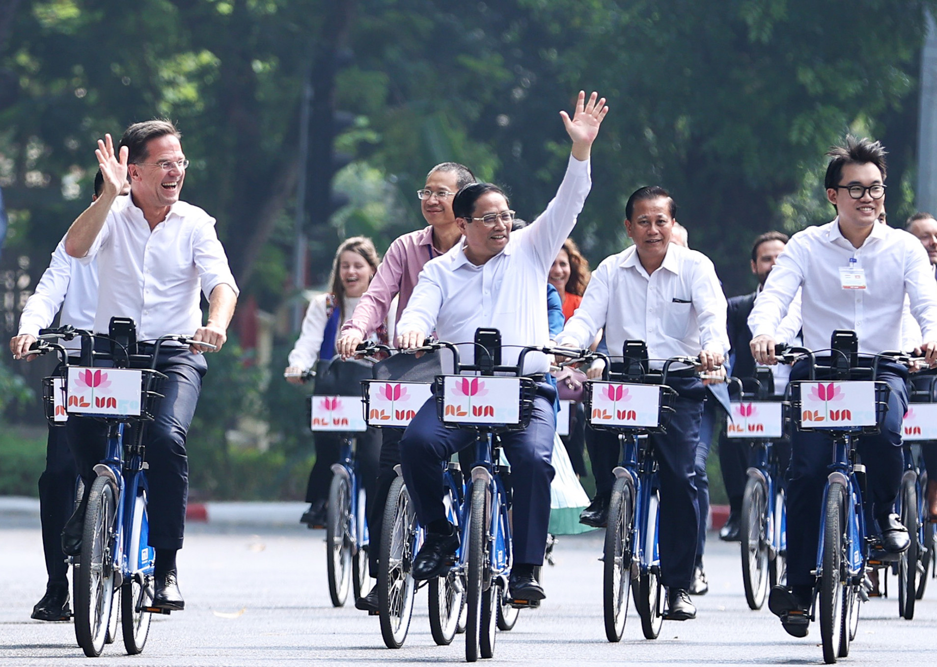 两国总理向途经的民众挥手致意。