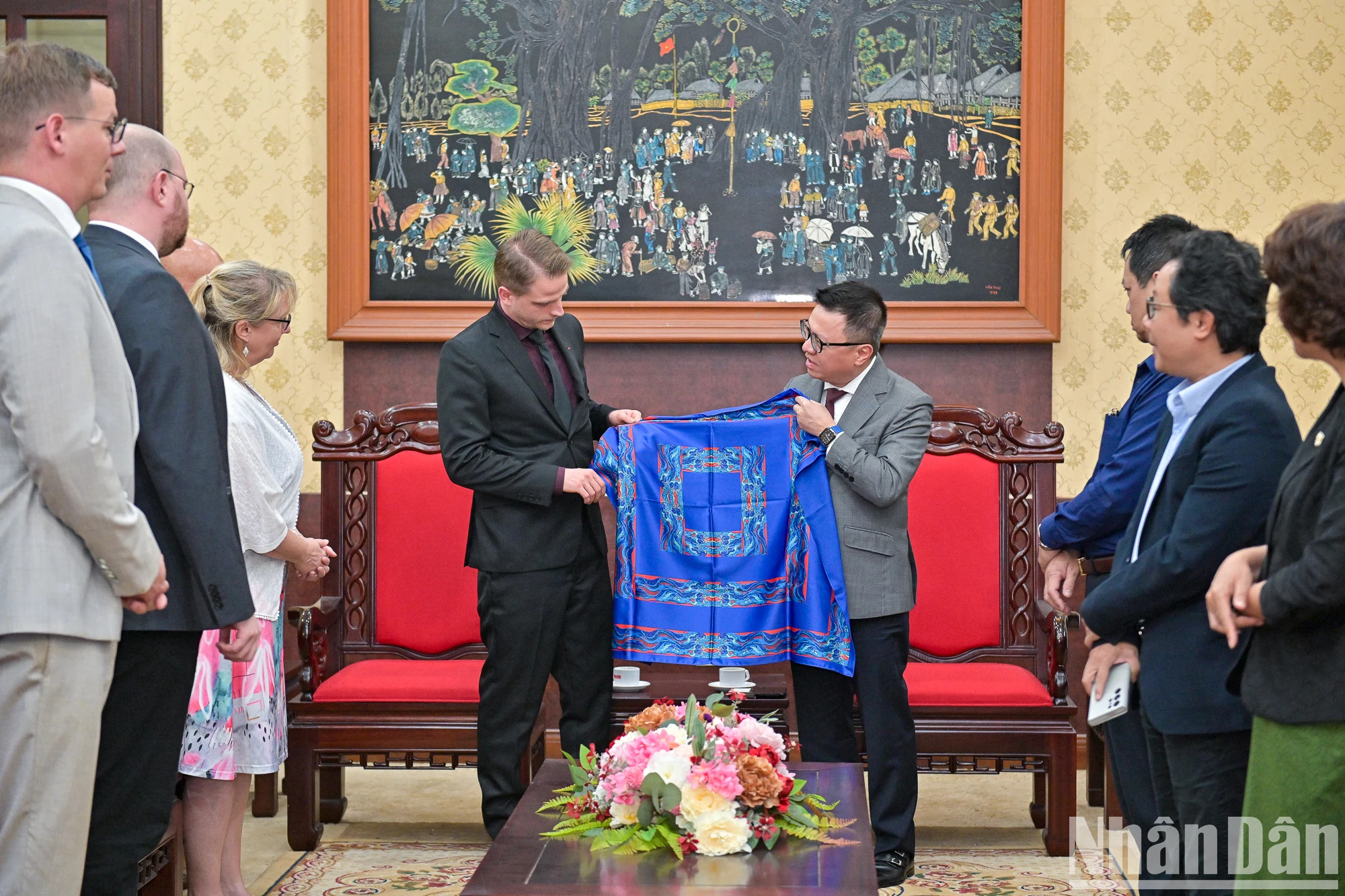 《人民报》社总编辑黎国明向德国左翼党代表团赠送了《人民报》独有的丝巾。