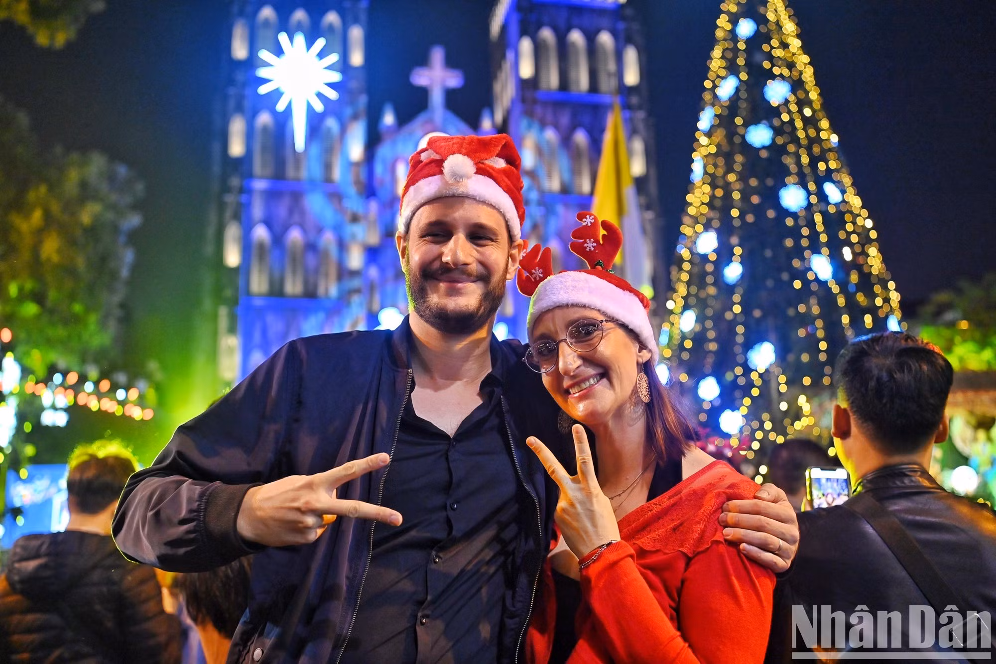 一对外国游客在河内大教堂享受圣诞气氛。 （成达 摄）