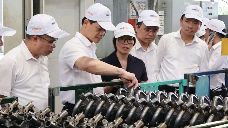 北宁省人民委员会主席王国俊（左二）参观Innotek股份公司的生产模式。