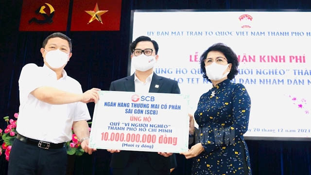 胡志明市祖国阵线委员会主席苏氏碧珠（右）接受捐款。