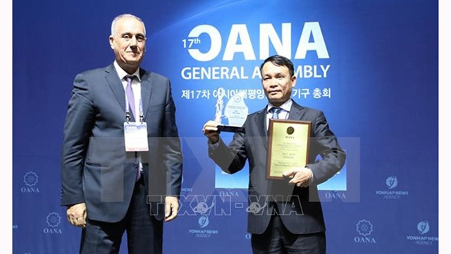 阮德利社长代表越通社上台受奖。（图片来源：越通社）