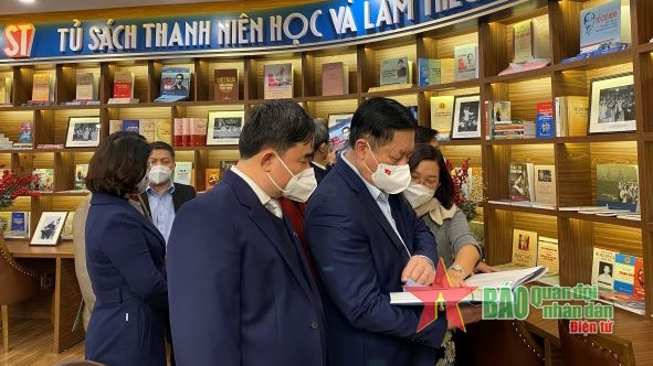 阮重义同志参观“青年学习和践行胡伯伯教诲”书柜。（图片来源：人民军报）