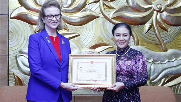 越南友好组织联合会主席阮芳娥大使向联合国开发计划署驻越南首席代表凯特林·维森女士授予“致力于各民族间和平与友谊”纪念章。
