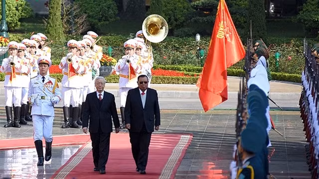越共中央总书记同老挝人民革命党中央委员会总书记、国家主席本扬•沃拉吉检阅仪仗队。（图片来源：VOV）