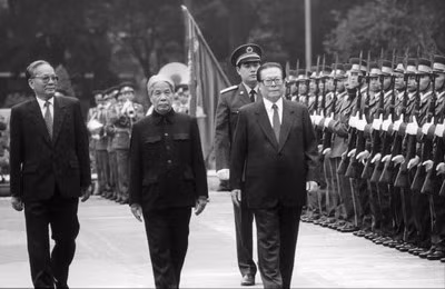 越共中央总书记杜梅、越南国家主席黎德英与中共中央总书记、中华人民共和国主席江泽民检阅仪仗队。 (Photo: 图片来源：越南《人民报》1994年11月21日)
