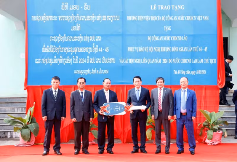越南公安部副部长梁三光上将向老挝公安部移交20辆汽车和30辆摩托车。