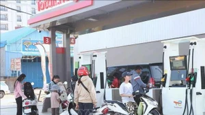 民众在柬埔寨东北部上丁省上丁市的一处加油站加油。