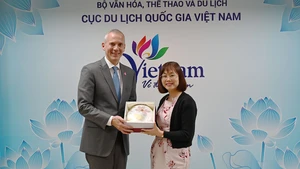 越南国家旅游局副局长阮氏花梅向阿塞拜疆旅游局首席执行官弗罗瑞恩·斯契米德赠送纪念品。（图片来源：TITC）