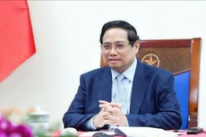 越南政府总理范明正与卡塔尔首相兼外交大臣通电话。（图片来源：VGP）