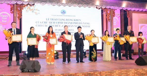 向模范外国个人和组织颁发奖状。