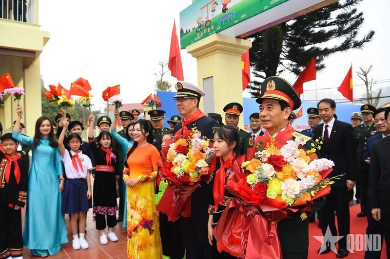 同学们向两位部长赠送献花。（图片来源：人民军队报）