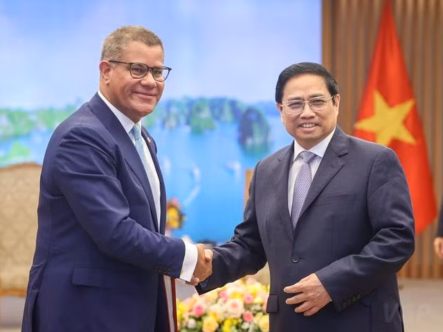 范明正总理与阿洛克·夏尔马主席握手。