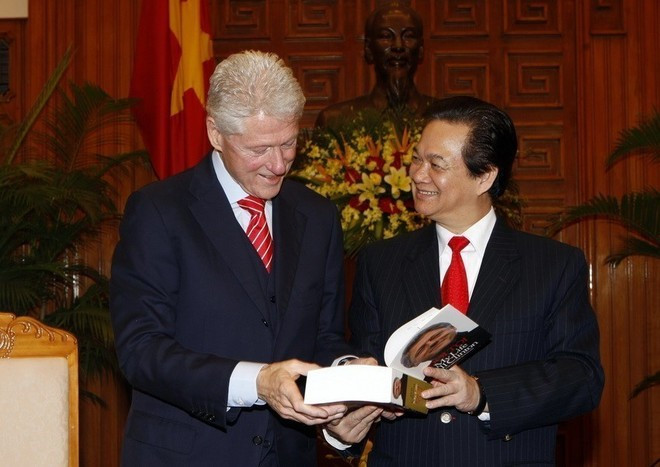 2010年11月14日，时任越南政府总理阮晋勇在河内向美国前总统比尔·克林顿赠送由越南公安部出版社出版的《我的人生：比尔·克林顿》一书。（图片来源：越通社）