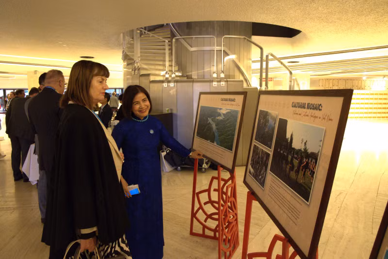 黎氏雪梅大使向国际友人介绍图片展。（图片来源：越通社）