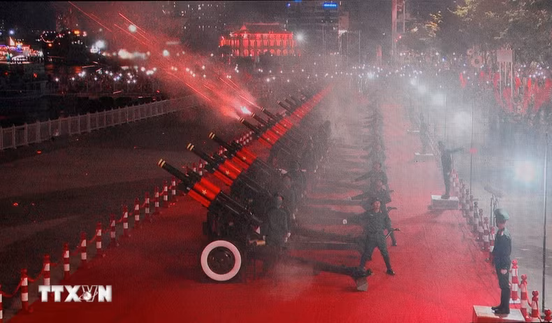 在纪念南方解放、国家统一50周年庆典的阅兵和游行活动的预演中，举行鸣礼炮升国旗仪式。（图片来源：越通社）