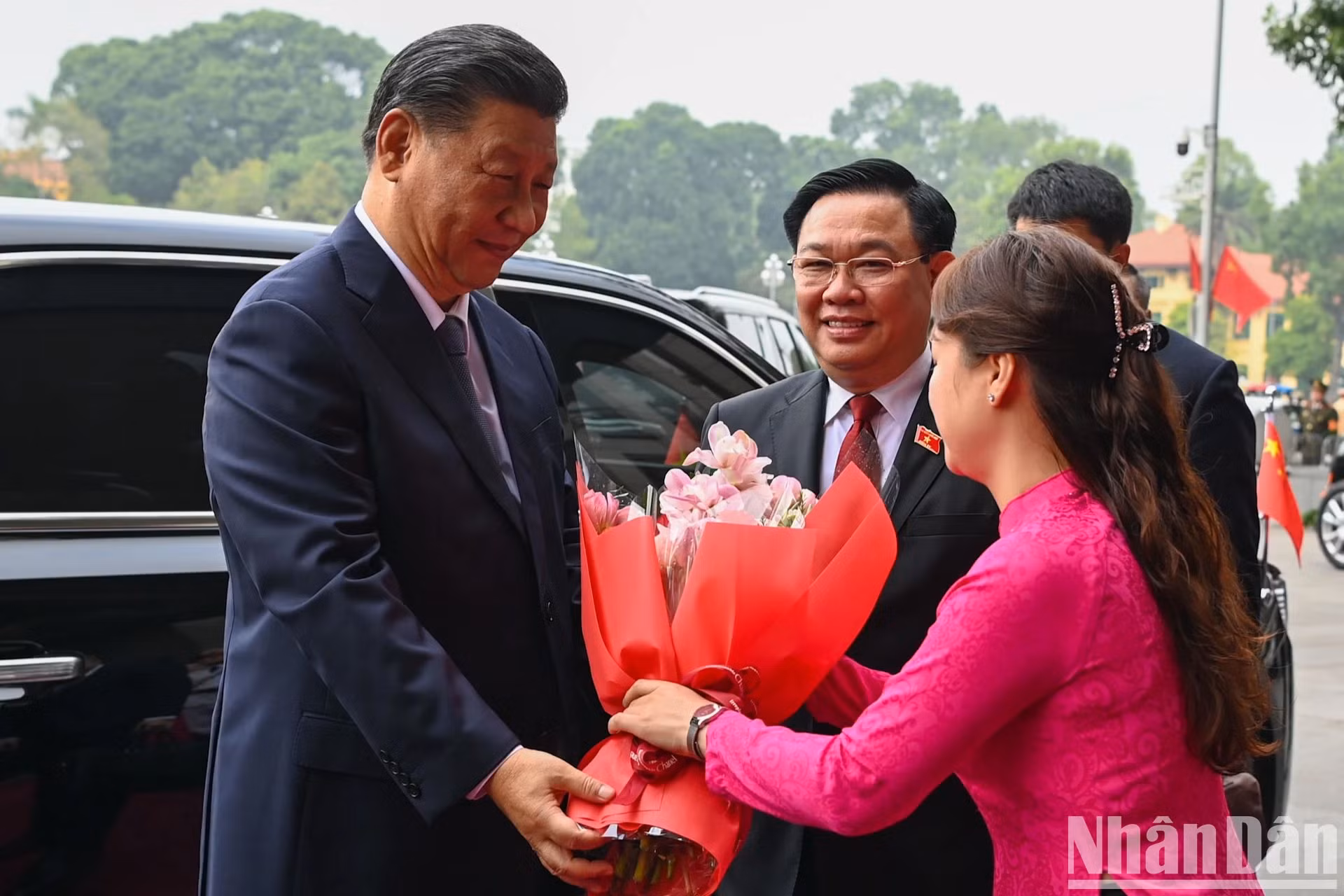 国会办公厅职员向习近平同志送花。