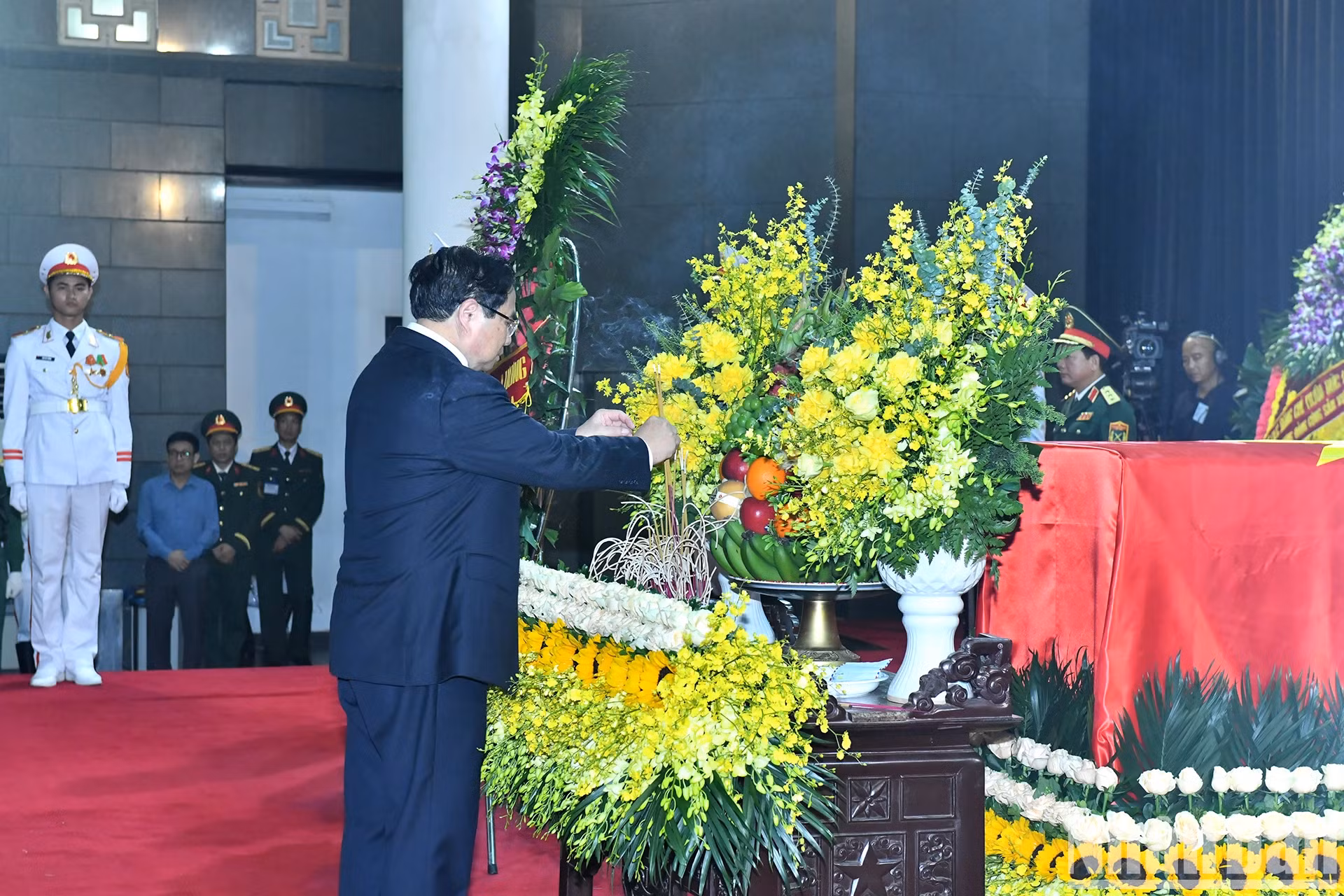 政府总理范明正向原国家主席陈德良敬香。