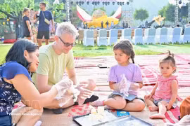 许多国际游客兴致勃勃地体验中秋节特色活动。（图片来源：越通社）