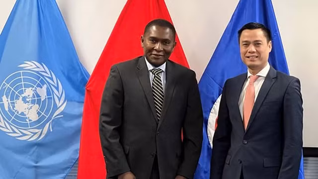 越南常驻联合国代表团团长邓黄江大使（右）与联合国助理秘书长塞尔温·哈特。