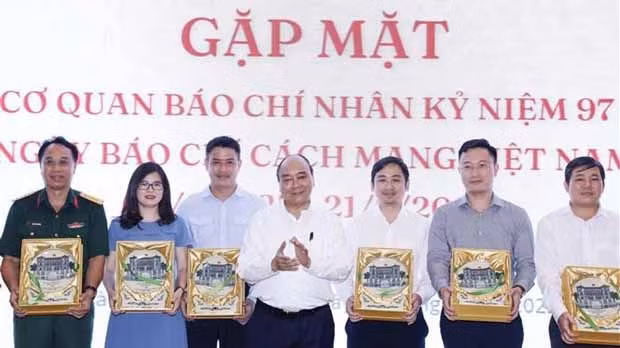 阮春福主席向胡志明市新闻媒体机构代表赠送礼物。（图片来源：越通社）