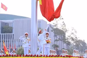 金星红旗在巴亭广场迎着曙光冉冉升起。（松梅 摄）