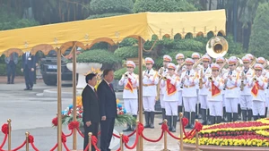 越共中央总书记苏林与老挝人民革命党中央总书记、老挝人民民主共和国主席通伦·西苏里登上检阅台。