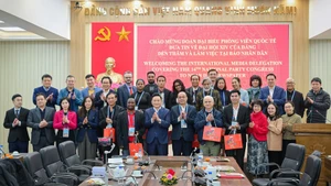 《人民报》社领导、干部，外交部代表与外国记者团合影留念。